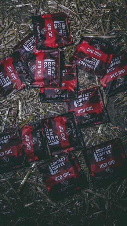 Red single serve coffee brew bag from Contact Coffee Company Ltd., ready for brewing a fresh cup of coffee.
