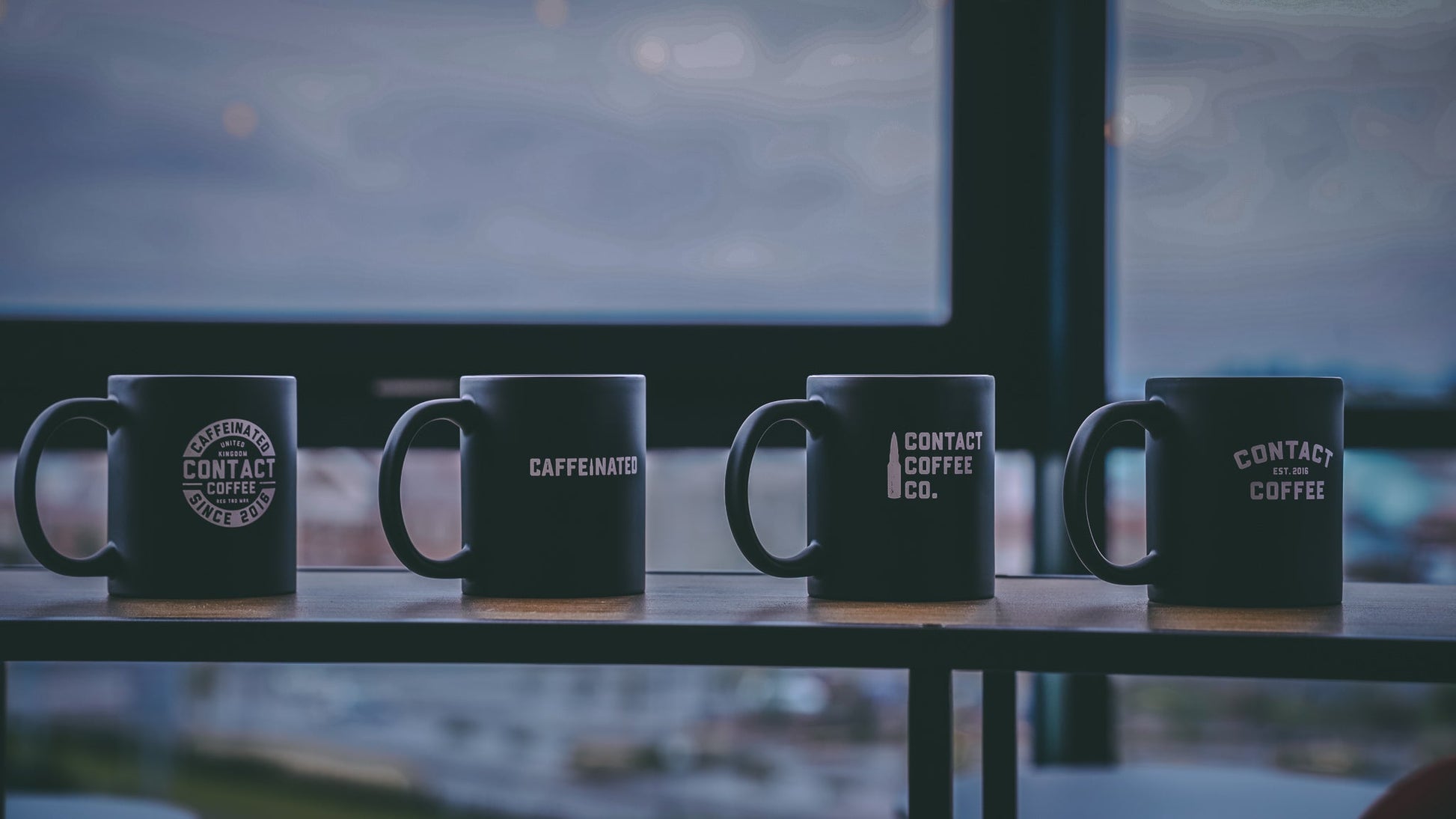 Contact Coffee Co mug featuring the Bravo gear design, with bold branding and a sturdy ceramic construction.