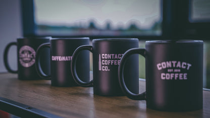 Contact Coffee Co Mug Alpha gear with bold logo, ceramic material, and sturdy handle for everyday coffee drinking.