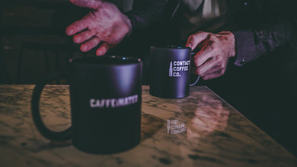 Contact Coffee Co Alpha mug featuring gear design, made of ceramic, with a sleek black finish and bold logo branding.
