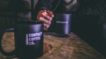 Contact Coffee Co mug featuring the Delta gear logo, ceramic coffee mug with a stylish design for coffee lovers.