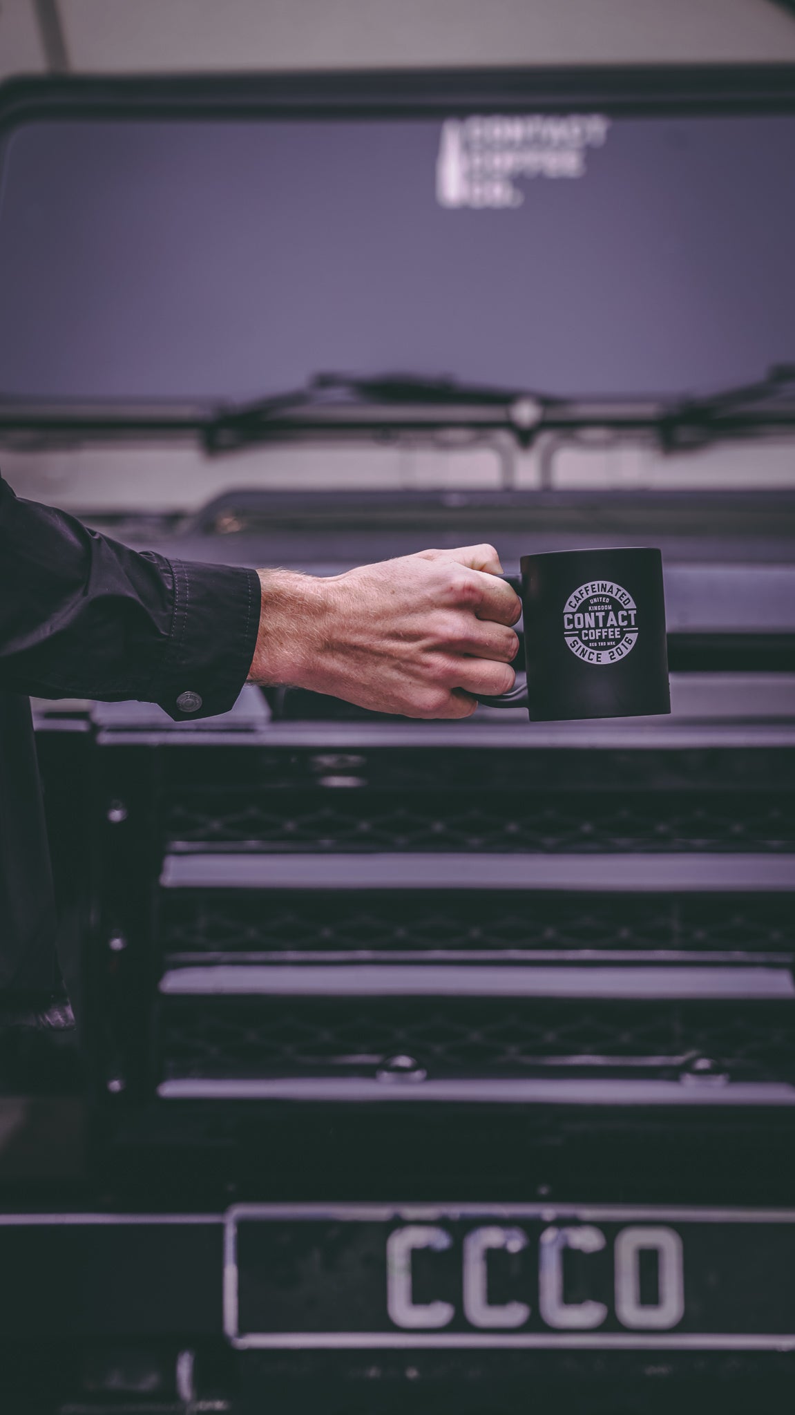 Contact Coffee Co mug featuring the Bravo gear logo, showcasing a ceramic coffee mug with branded contact coffee company design.