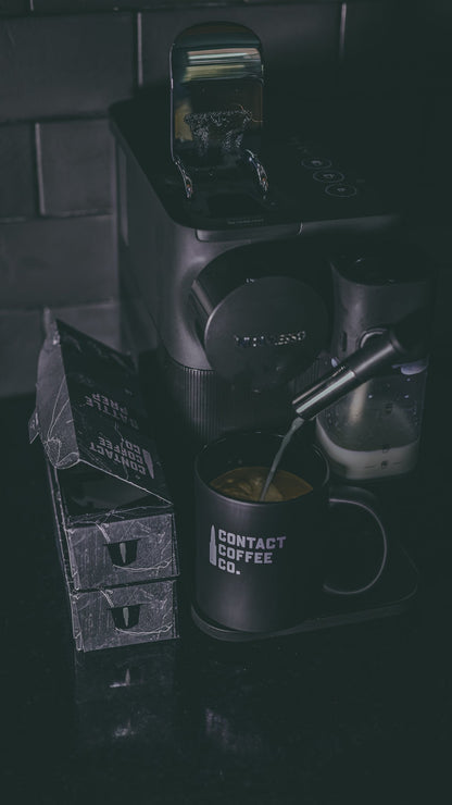 Aluminium Nespresso coffee pods from Contact Coffee Company Ltd., showing sleek, sealed coffee capsules in a close-up shot.