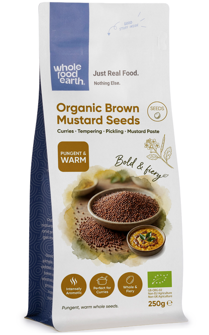 Organic brown mustard seeds from Whole Food Earth, close-up of small round seeds in a jar, fresh herbs and spices.