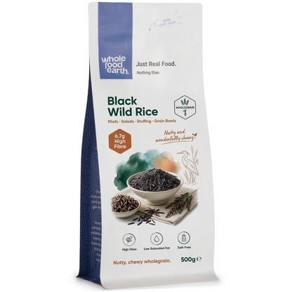 Black Wild Rice from Whole Food Earth, a close-up of cooked black wild rice grains on a white background.