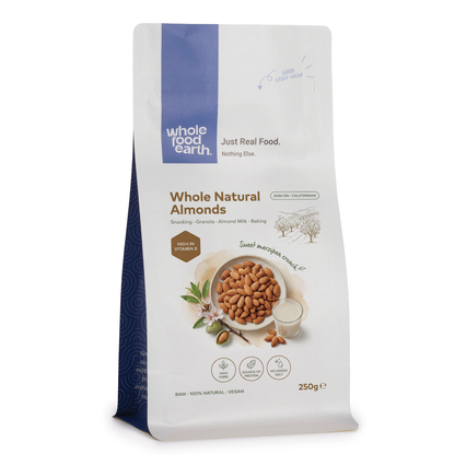 Whole Food Earth natural almonds, whole nuts and seeds, displayed in a clear container, showcasing their crunchy texture and light brown color.