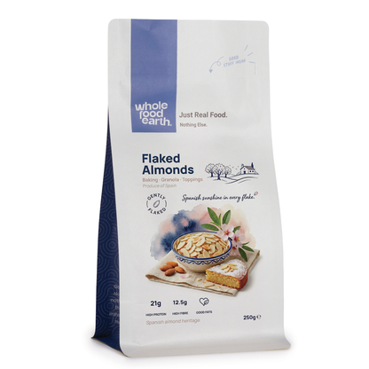 Whole Food Earth flaked almonds, crunchy sliced nuts and seeds, shown in a clear container with golden toasted almond flakes.