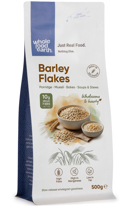 Whole Food Earth barley flakes cereal in a bowl, showing golden toasted barley flakes on a white background