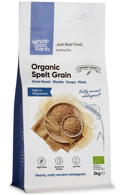 Organic spelt grain from Whole Food Earth, showing a close-up of light brown spelt kernels in a natural setting.