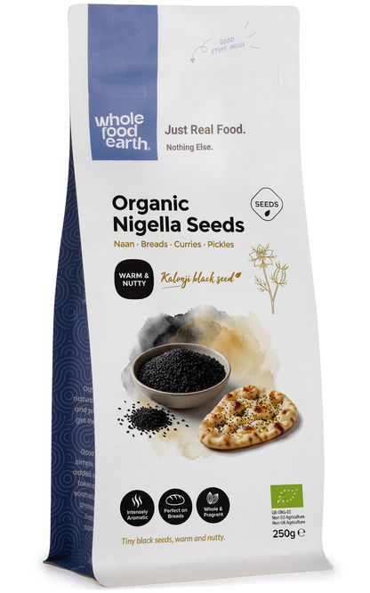 Organic Nigella seeds from Whole Food Earth, close-up view of small black seeds in a glass jar for herbs and spices.