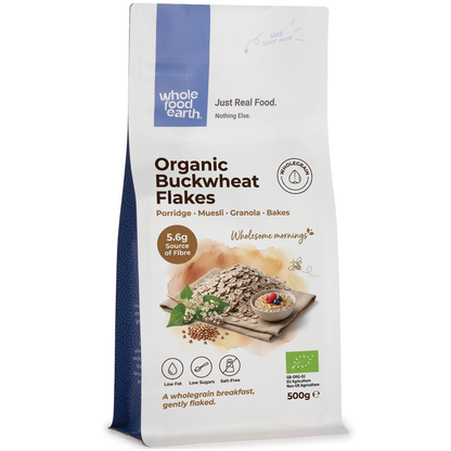 Organic buckwheat flakes cereal in a clear bowl, showing golden-brown organic Whole Food Earth buckwheat flakes on a white background.