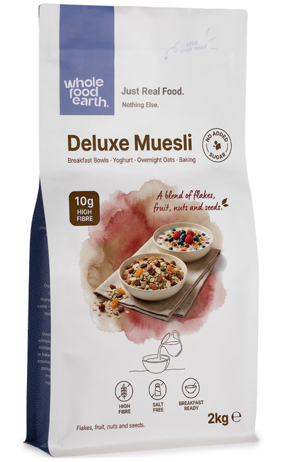 Whole Food Earth Deluxe Muesli cereal with flakes, dried fruit, nuts, and seeds in a bowl for a healthy breakfast.
