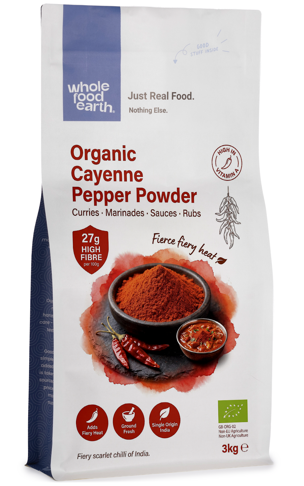 Organic cayenne pepper powder in a clear glass jar, labeled as Whole Food Earth herbs and spices, with red chili flakes inside.