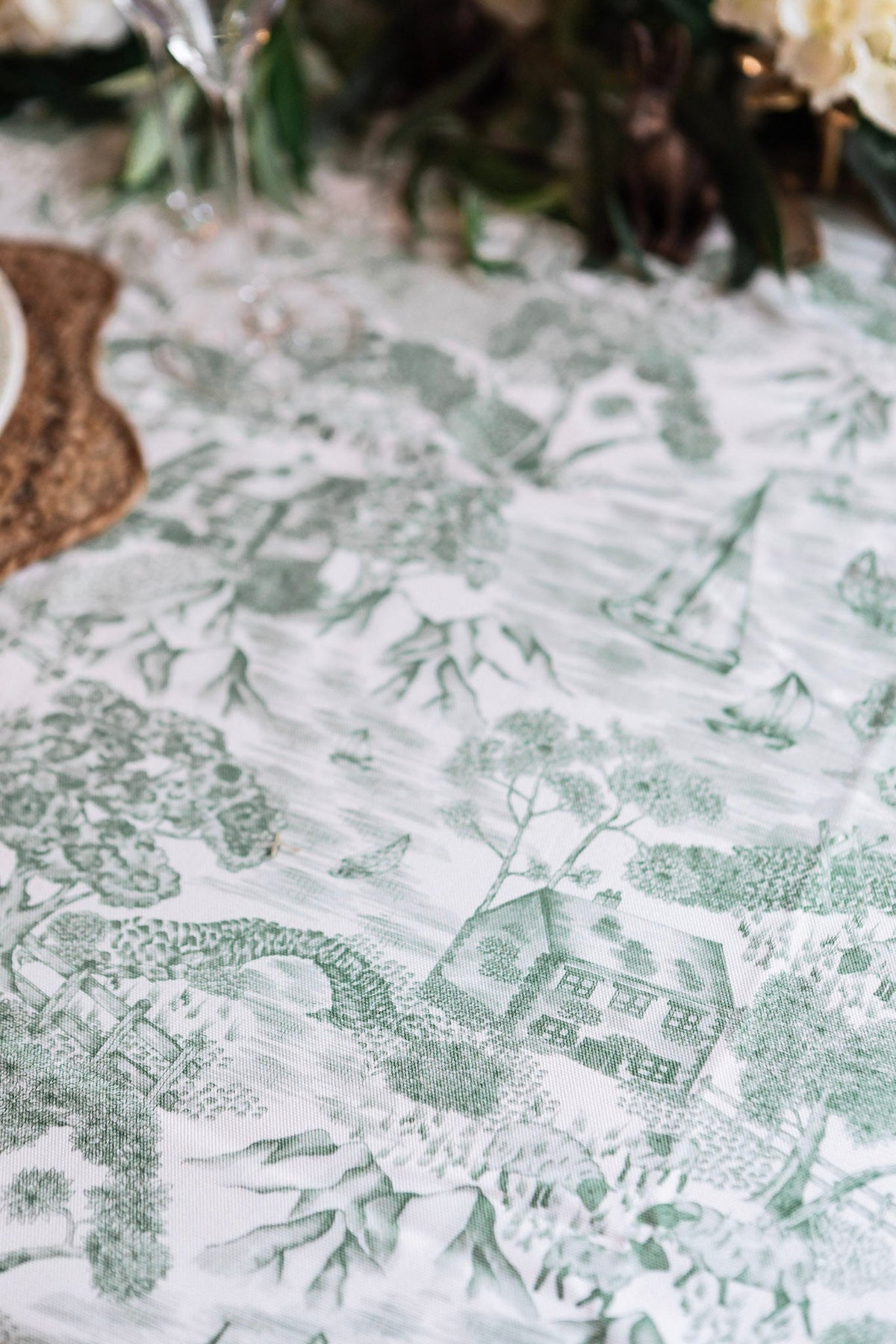 Avalon Home UK Lake District Toile tablecloth featuring classic blue and white scenic pattern, draped over a dining table.