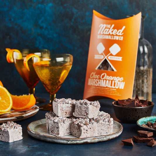 Golden orange and chocolate gourmet marshmallows from THE MARSHMALLOW FACTORY, showing soft, fluffy texture and vibrant orange coating.
