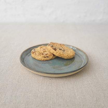 Seafoam blue ceramic cake plate by Katie L Thompson Designs, featuring a classic round shape and decorative pattern.