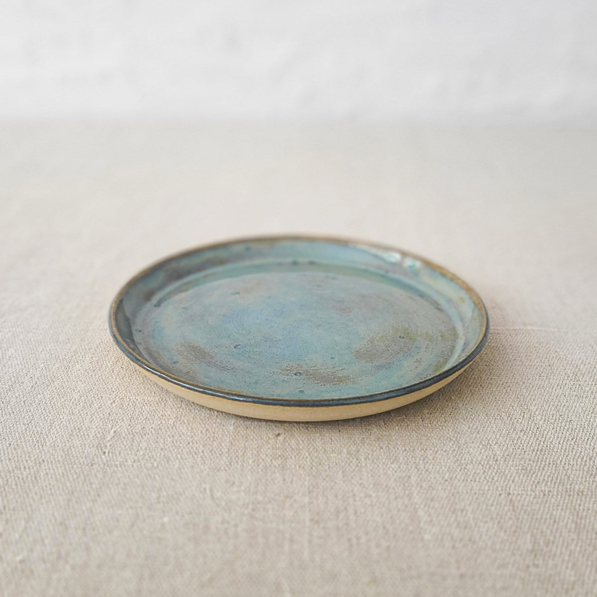 Seafoam blue classic cake plate by Katie L Thompson Designs, featuring a smooth round surface and elegant design.