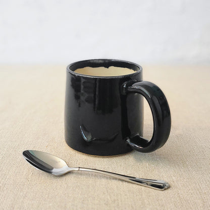 Jet black ceramic standard mug by Katie L Thompson Designs, featuring a sleek, smooth finish and classic shape.