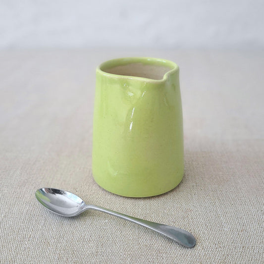 Spring green small ceramic jug by Katie L Thompson Designs with a classic shape and smooth finish.