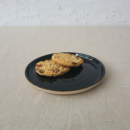 Jet black classic cake plate by Katie L Thompson Designs, featuring a sleek round design perfect for serving desserts.