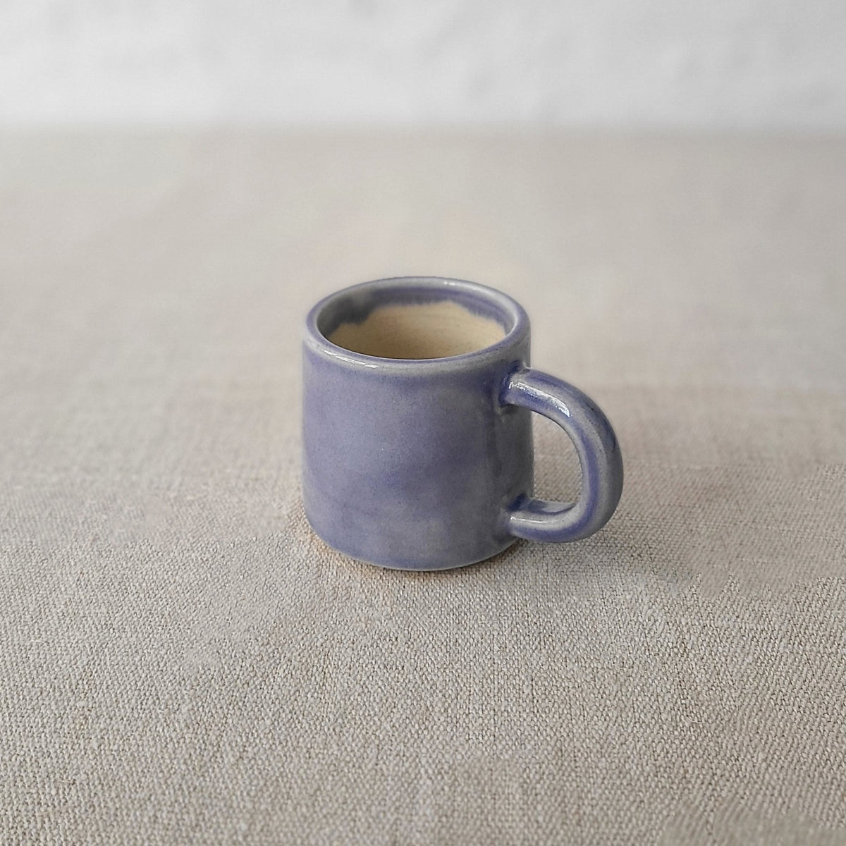 Amethyst purple ceramic espresso mug with classic design by Katie L Thompson Designs, shown from a side view with a smooth finish.