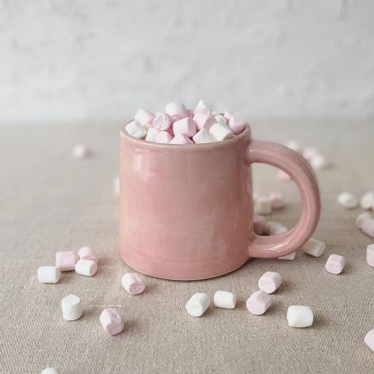 Blush pink classic standard mug with Katie L Thompson Designs logo, ceramic cup with smooth surface and rounded handle.