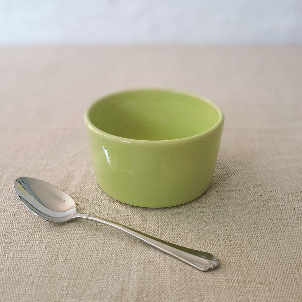 Spring green classic side bowl by Katie L Thompson Designs, featuring a smooth, round ceramic shape with a glossy finish.