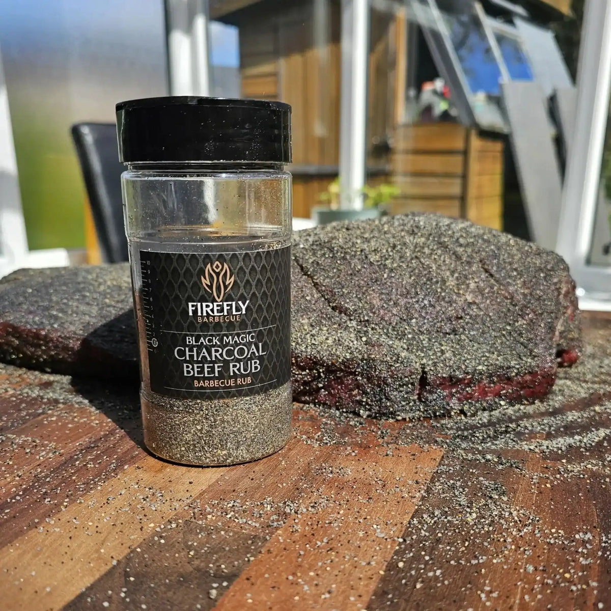 FireFly Barbecue Black Magic Charcoal Beef Rub in a jar, seasoned BBQ rub for grilling and smoking beef dishes.