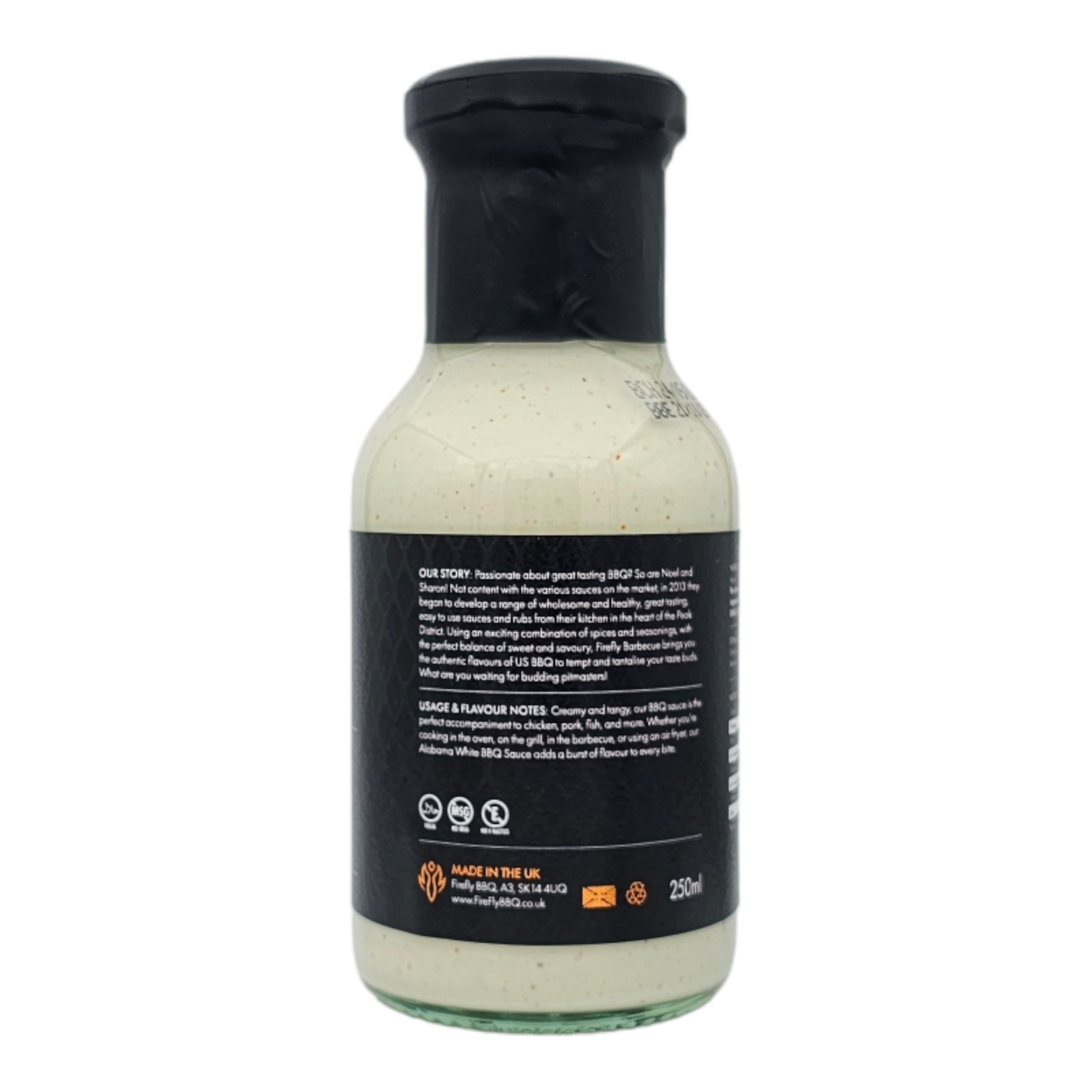 Bottle of FireFly Barbecue Alabama White BBQ Sauce with label visible, creamy white sauce in a squeeze bottle, ready for grilling.
