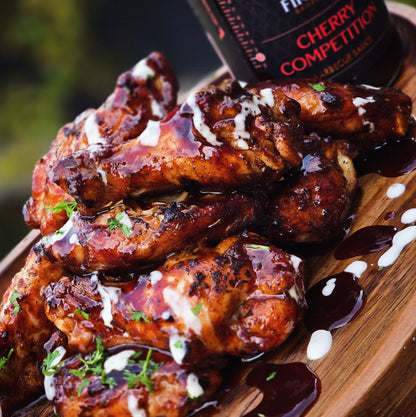 Bottle of FireFly Barbecue Competition Cherry BBQ Sauce, American Royal Best on the Planet, featuring a label with cherry imagery.