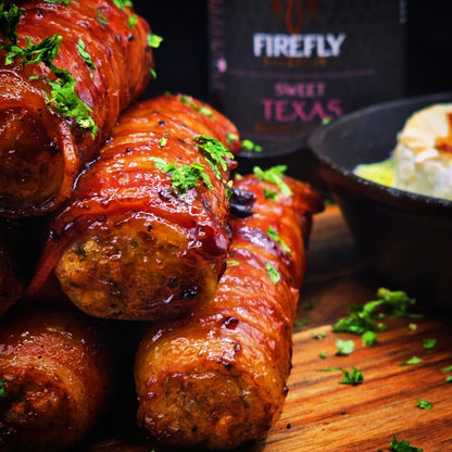 Bottle of FireFly Barbecue Sweet Texas BBQ Sauce with label and pouring spout on a wooden surface.