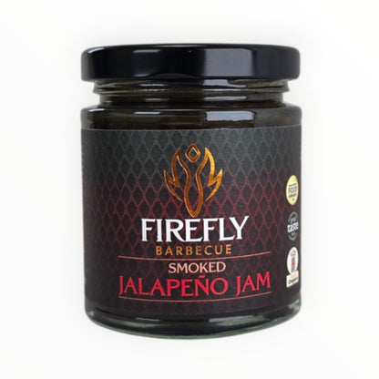 Smoked jalapeño jam hot sauce by FireFly Barbecue in a glass jar with a spoon, showcasing its smoky, spicy appearance.
