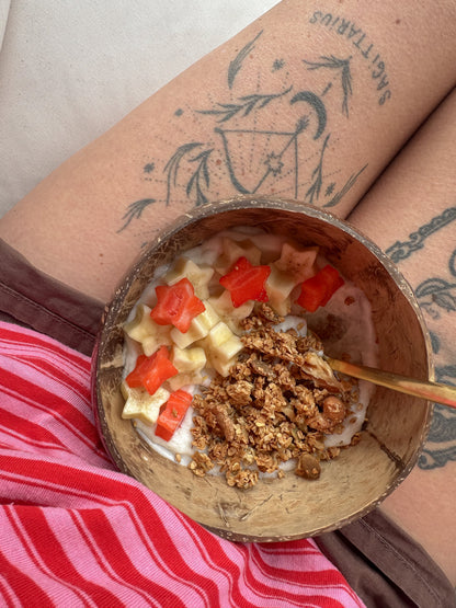 Gurt Lush Food Co nut, seed, and sultana granola in a bowl with visible nuts, seeds, and dried sultanas on top.