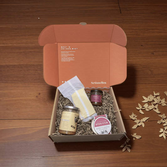 Gift box with food products on a wooden surface