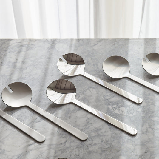 Borough salad servers by Aaron Probyn featuring sleek stainless steel design with wooden handles for serving salads.