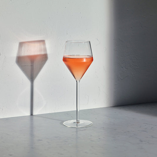 Set of two Aaron Probyn Juniper white wine glasses with clear glass and elegant stems on a white background.