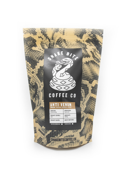250g package of Snake Bite Coffee Anti-Venom decaffeinated Colombia coffee beans in a resealable bag.