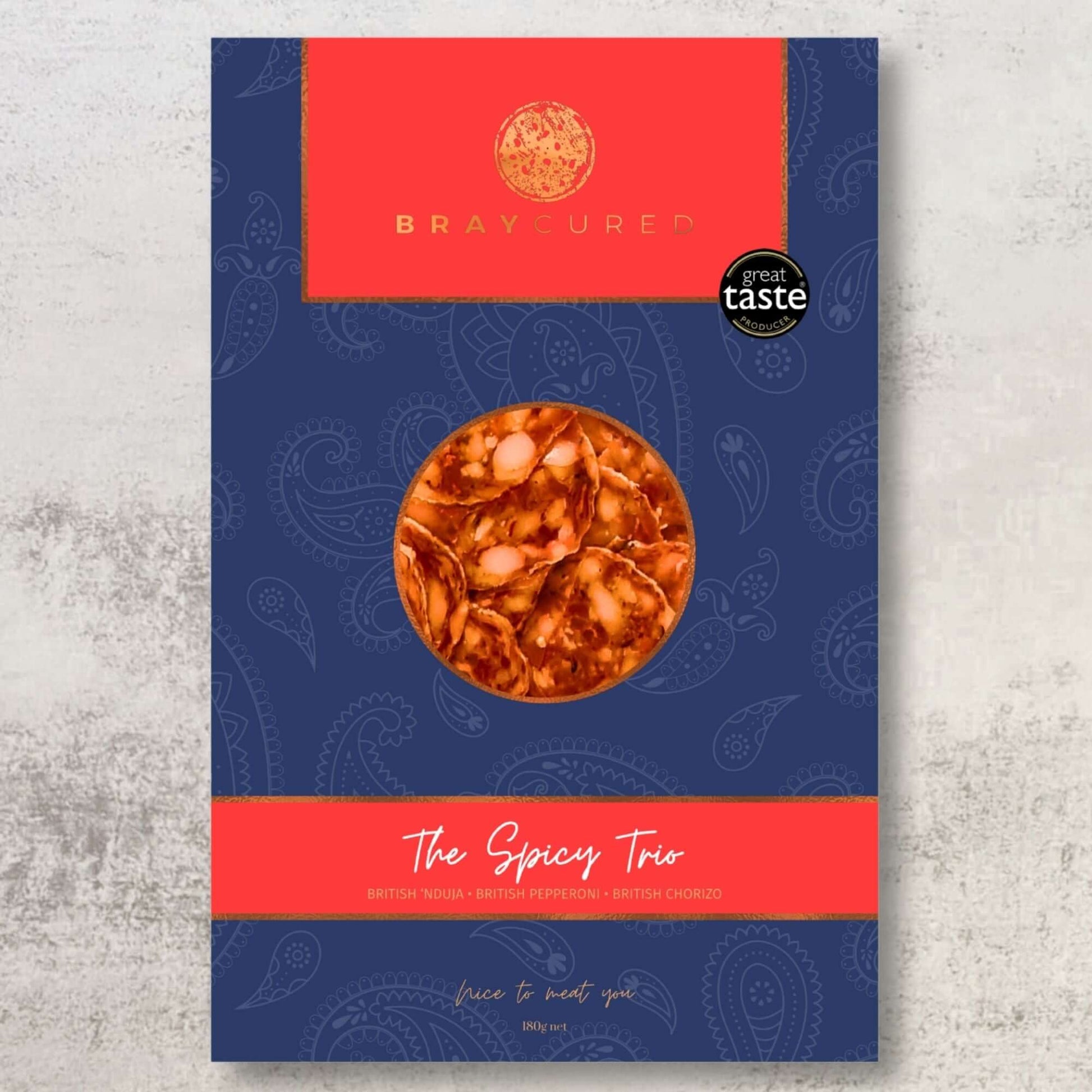 Bray Cured Spicy Tasting Trio featuring a selection of flavorful cured meats on a wooden board.