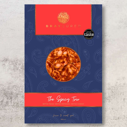 Bray Cured Spicy Tasting Trio featuring a selection of flavorful cured meats on a wooden board.