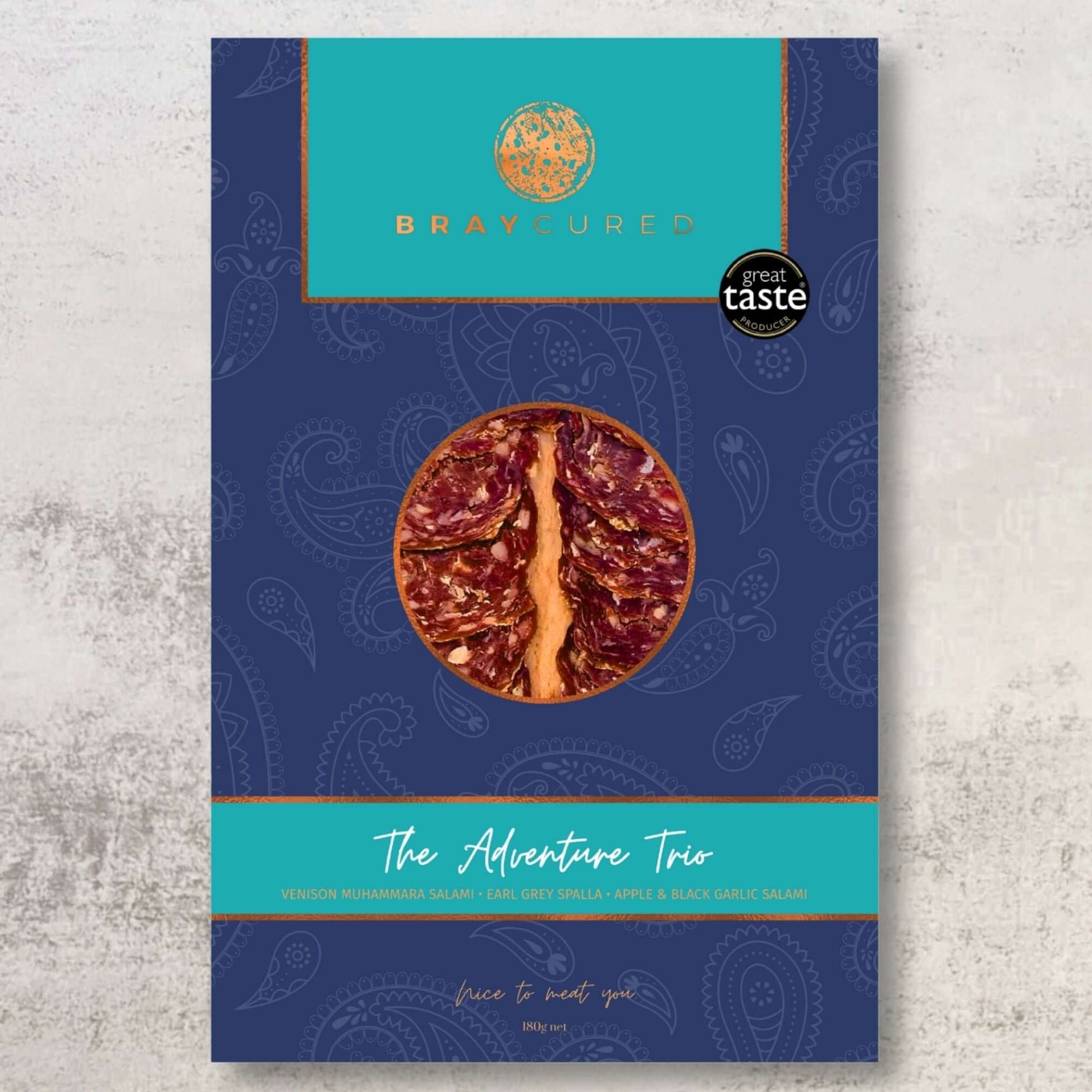 Assorted Bray Cured Adventure Tasting Trio featuring a selection of cured meats on a wooden platter.
