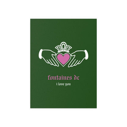Irish Claddagh poster by Fontaines DC featuring green design, displayed on a wall, with the band name and Celtic heart symbol visible.