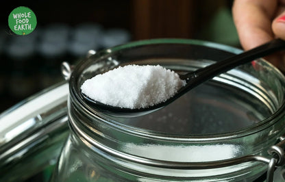 Fine sea salt crystals from Whole Food Earth, a natural mineral salt with a coarse texture and pure white appearance.