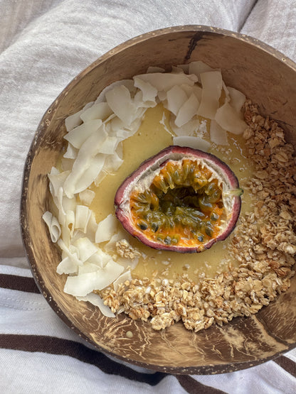 Bowl of honey and vanilla granola from Gurt Lush Food Co with visible clusters and flakes on a white background.