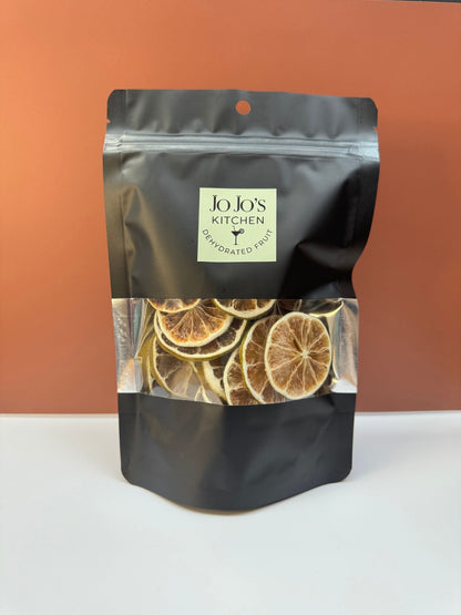 Dehydrated lime slices from JoJo’s Kitchen showing thin, dried citrus rounds with vibrant green and yellow hues.