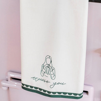 Avalon Home UK excuse you tea towel with playful printed text, shown draped over a kitchen counter.