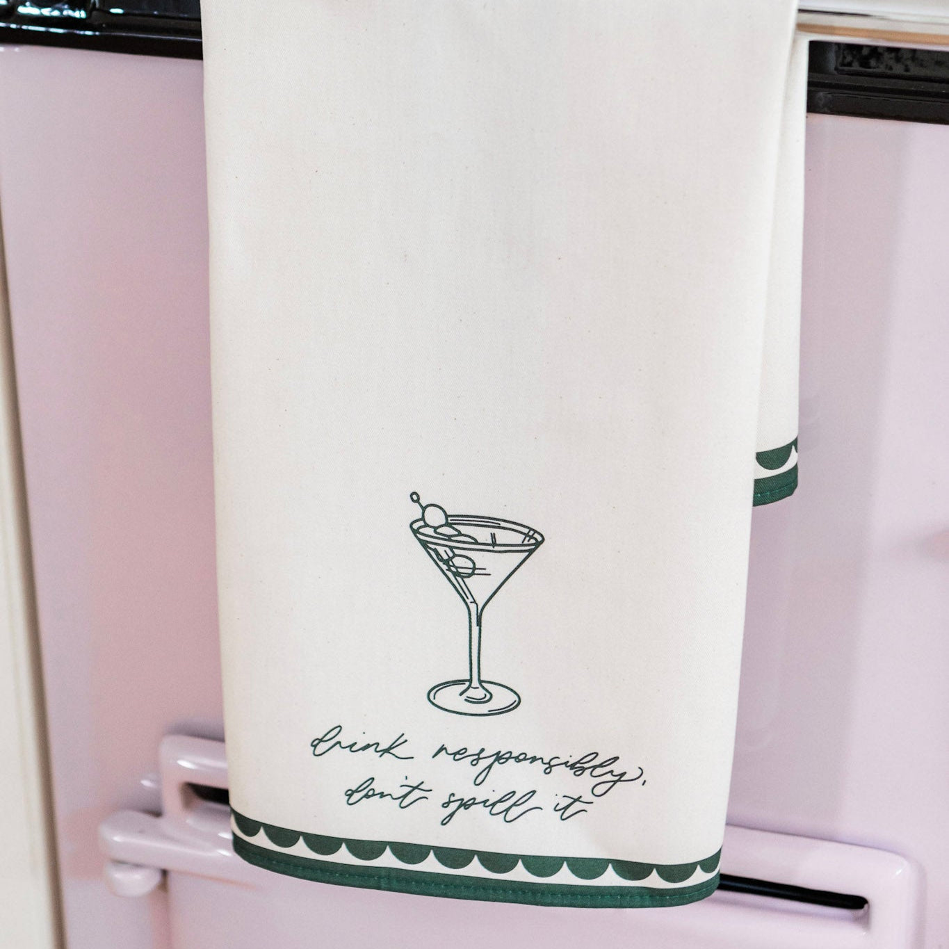 Avalon Home UK tea towel with "Drink Responsibly, Don't Spill Tea" printed in black on white fabric.