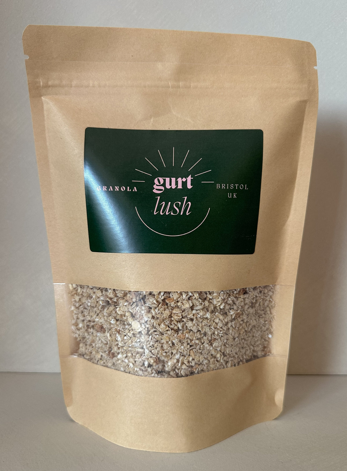 Honey and vanilla granola by Gurt Lush Food Co displayed in a bowl with clusters and oat flakes.
