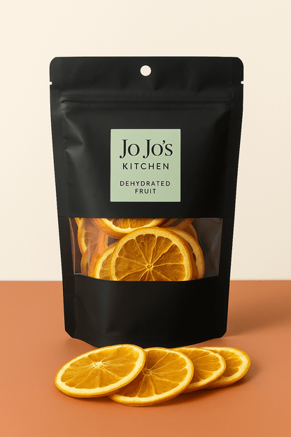 Dried dehydrated orange slices from JoJo’s Kitchen, bright orange fruit with textured surface, perfect for snacks or garnishing.