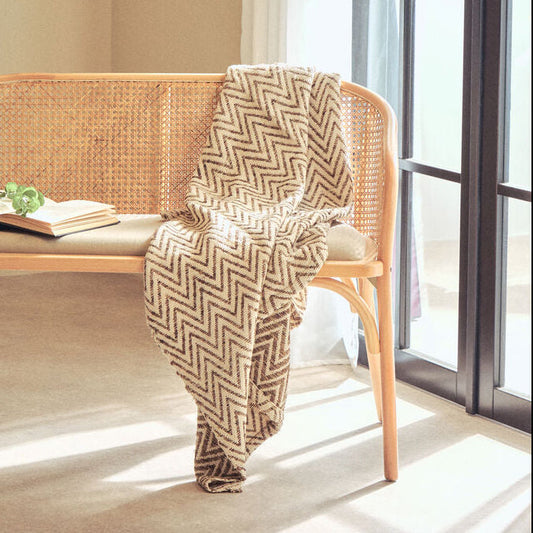 Orsina beige woven chevron throw blanket with textured pattern folded on display