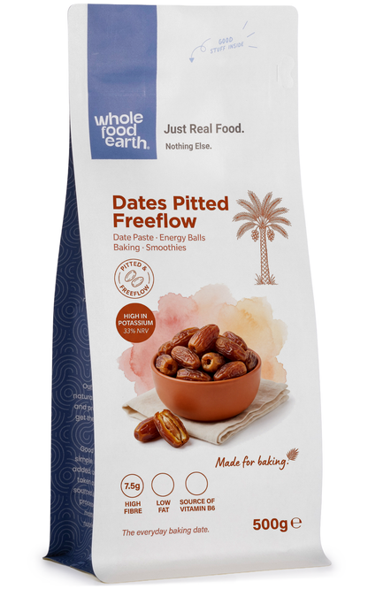 Pitted free-flow dried dates by Whole Food Earth, showcasing glossy, dark brown dates with smooth surface in a natural setting.